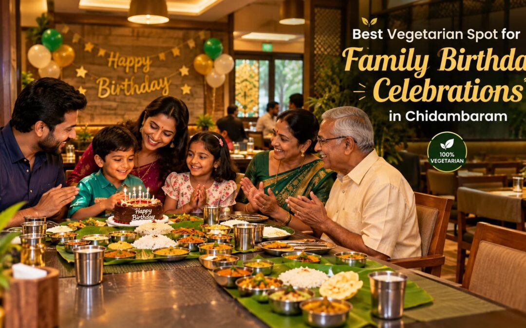 Family celebrating a birthday with a vegetarian thali spread and cake at a restaurant in Chidambaram